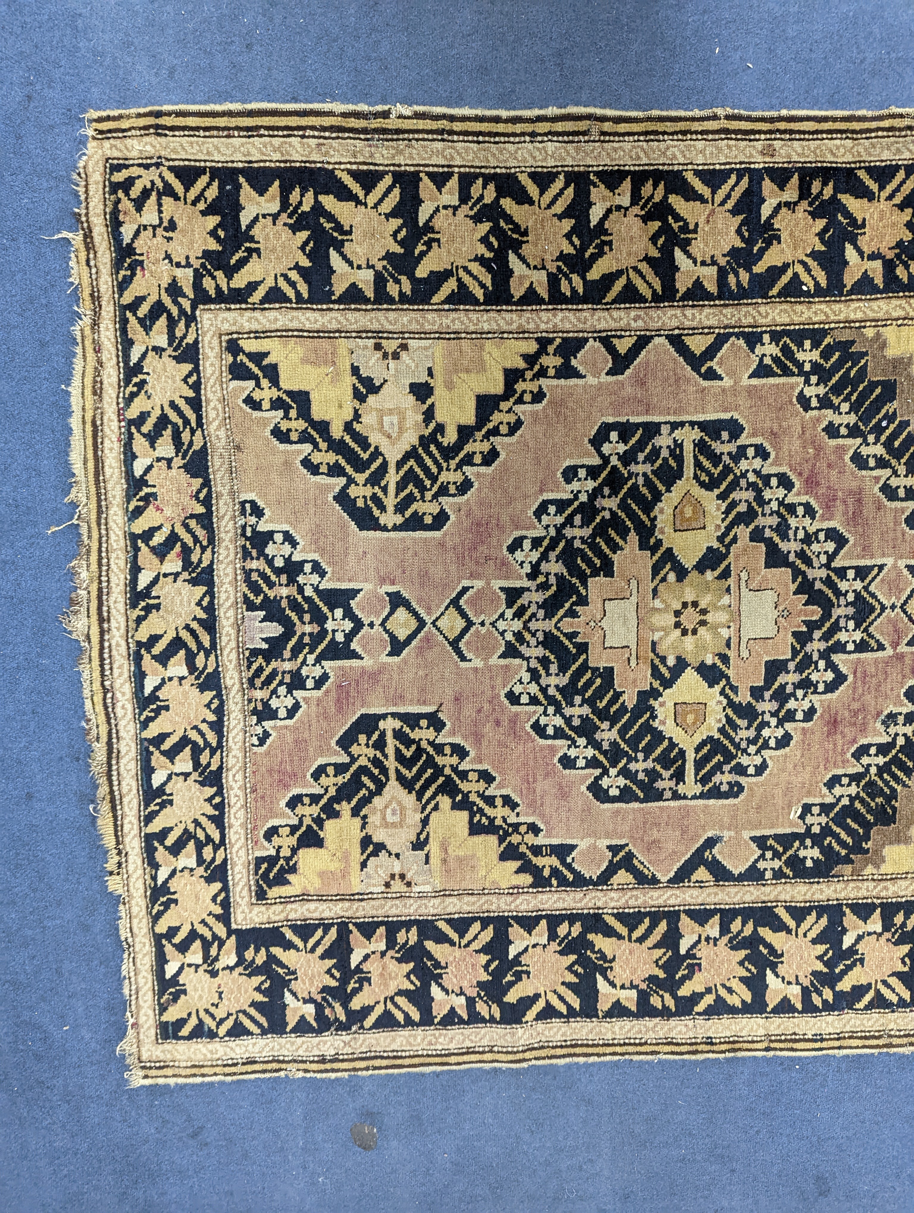 A Caucasian pink ground runner, woven with geometric devices, 483 x 107cm